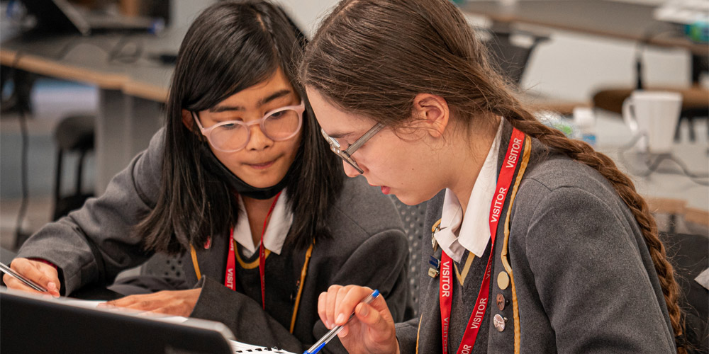 Two school students studying a page at a desk