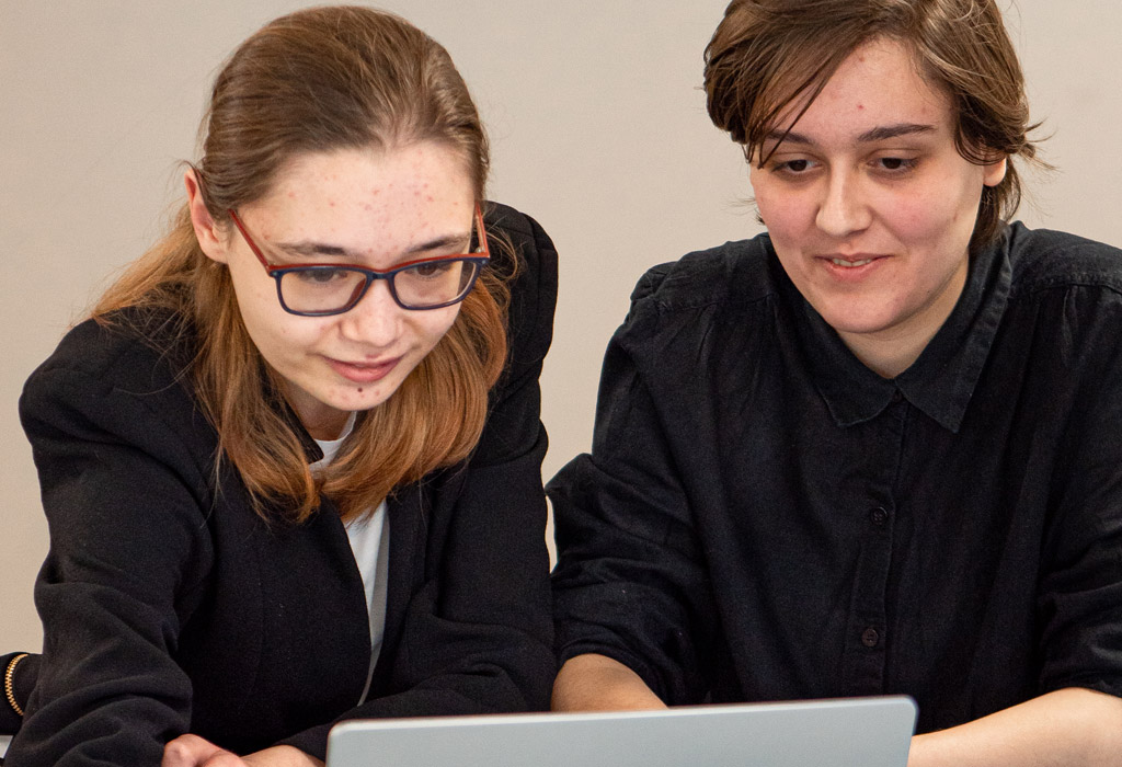 Students looking at a laptop screen