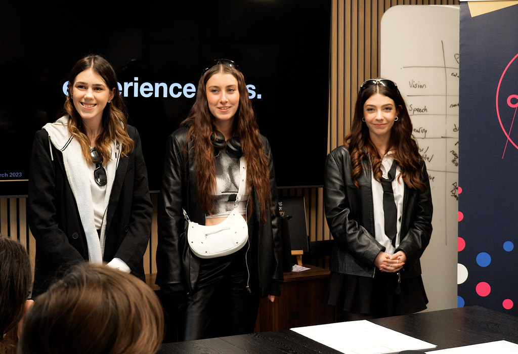 Three students presenting their work