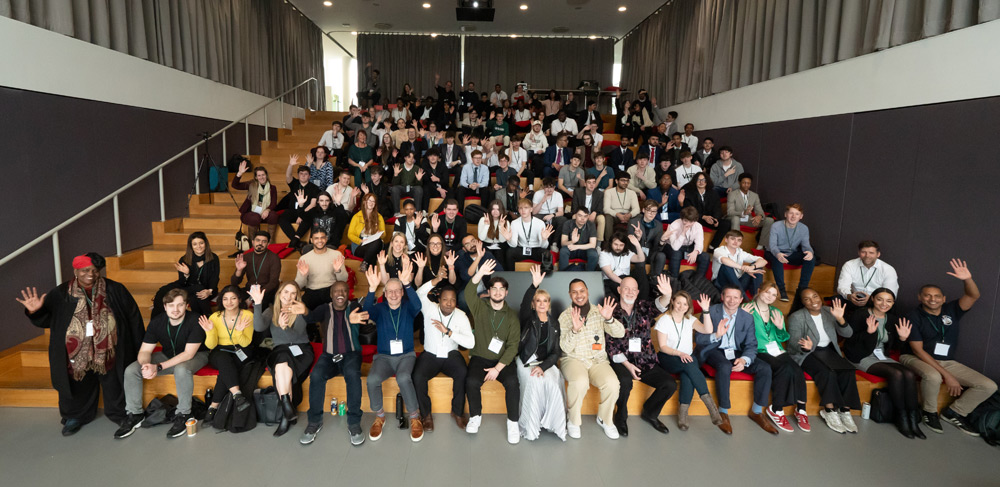 Student and speakers sit in the tiered lecture theatre at Wavemakers head office in central London